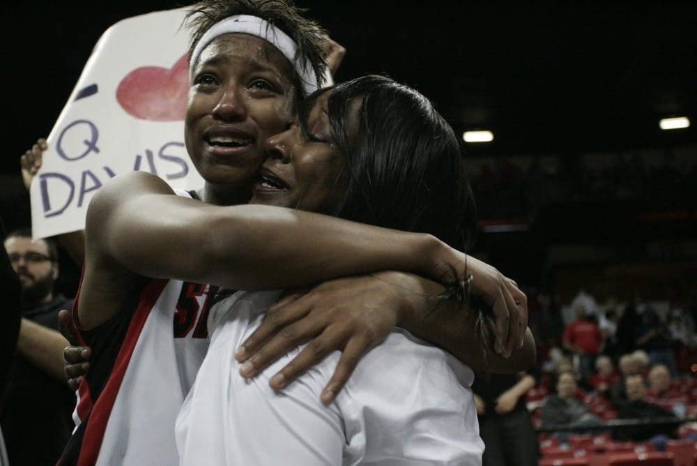 	Jene Morris elatedly hugs a member of her family on Saturday at the Thomas &amp; Mack Center. The Aztecs&#8217; men&#8217;s and women&#8217;s programs swept the MWC tournament titles.