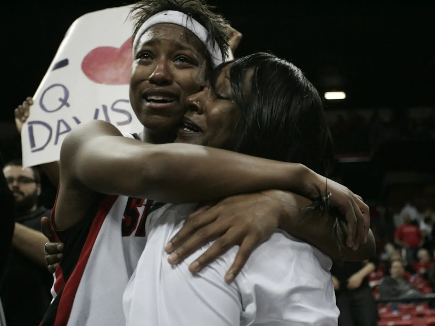 Jene Morris elatedly hugs a member of her family on Saturday at the Thomas & Mack Center. The Aztecs’ men’s and women’s programs swept the MWC tournament titles.