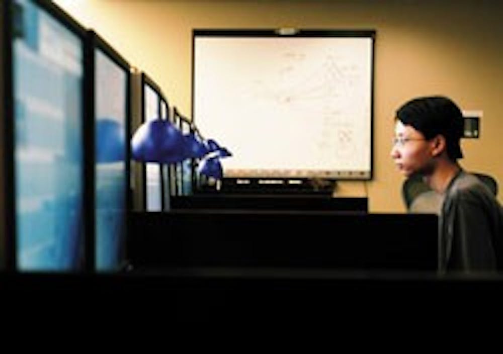 UNM senior Tuan Bui waits to assist customers in CIRT's Enterprise Command Center on Wednesday. Customer service is one of the areas that CIRT and the Telecommunications Department plan to reorganize when they merge. 