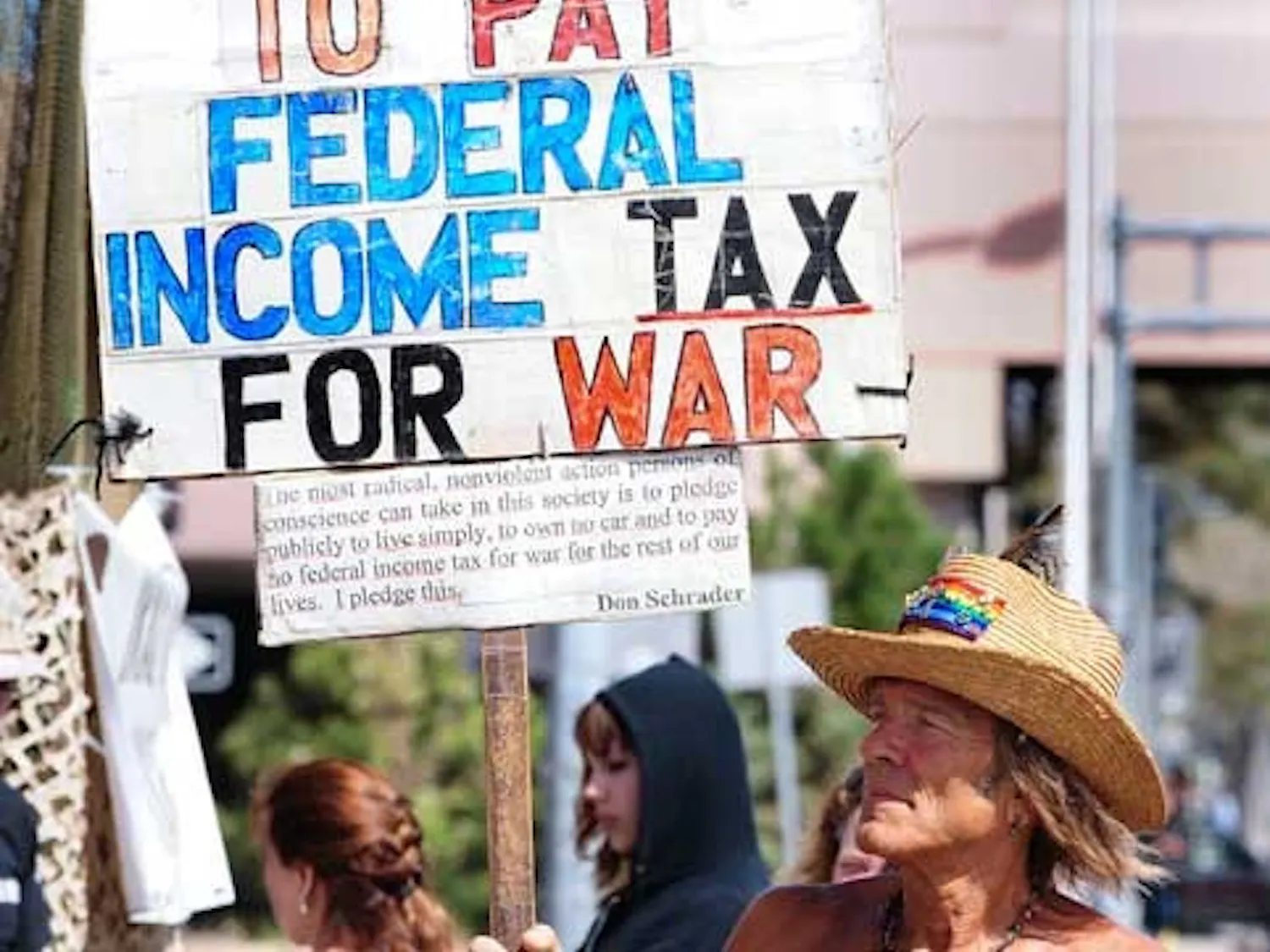 Don Schrader holds a sign protesting U.S. military operations during a rally at Galleria Plaza on Saturday.