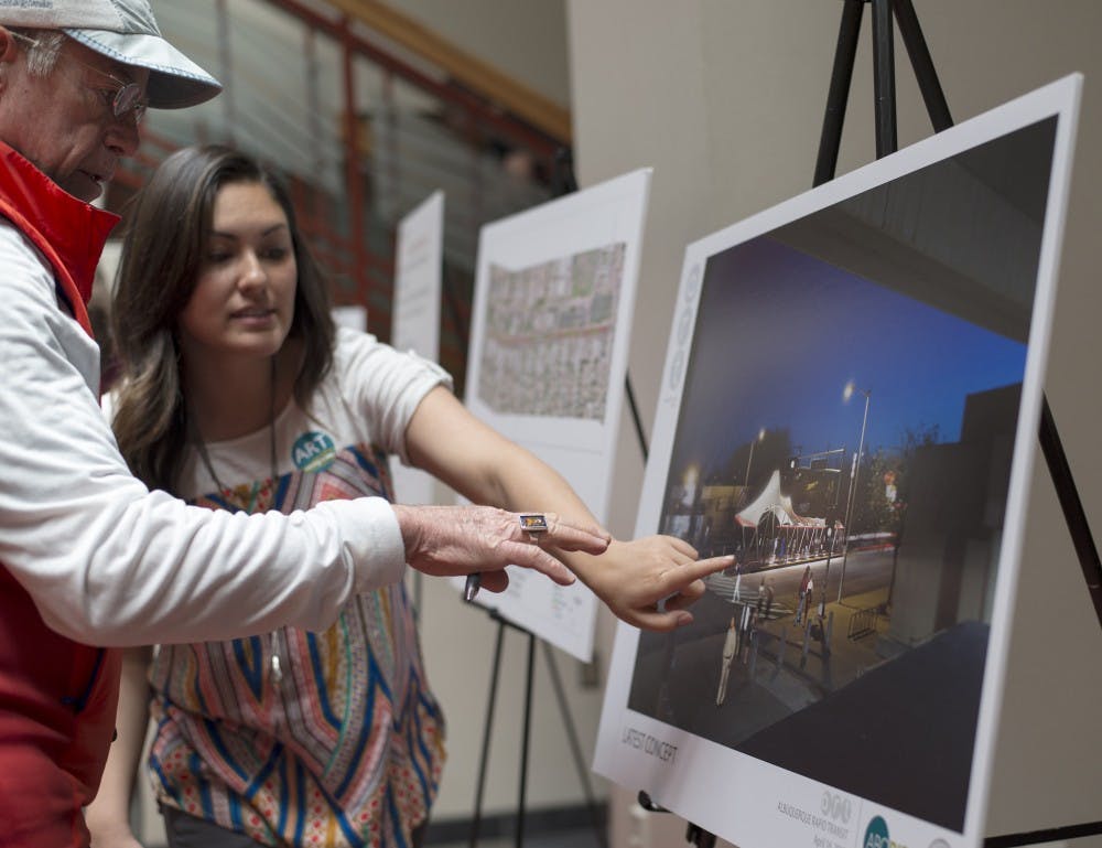 Davida Hollis explains to Josep Powers how the new Albuquerque Rapid Transit Cornell location will look. ART plans to develop multiple transit systems that run across Albuquerque, making public transportation faster than the pre-existing bus systems. 