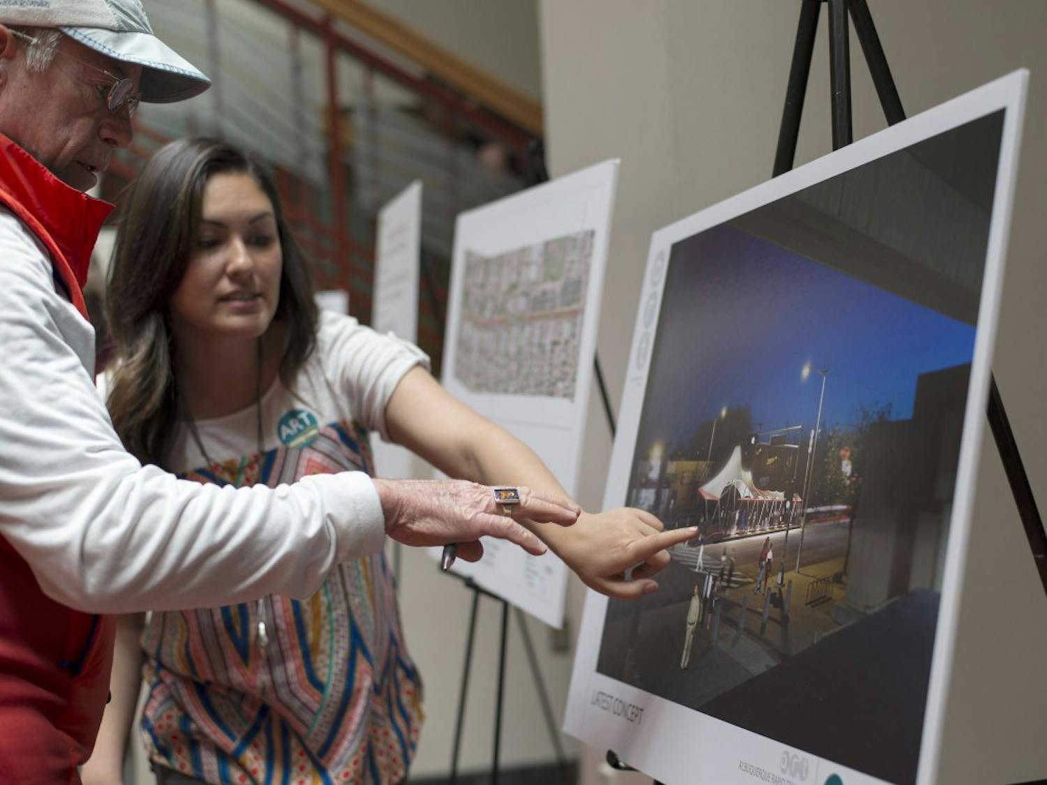 Davida Hollis explains to Josep Powers how the new Albuquerque Rapid Transit Cornell location will look. ART plans to develop multiple transit systems that run across Albuquerque, making public transportation faster than the pre-existing bus systems. 