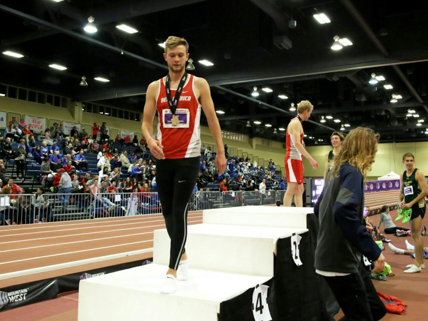 Sophomore distance runner Josh Kerr walks off the podium after coming in first for the mens mile at the Mountain West Track and Field Championship. Kerr was named national athlete of the week due to his most recent 1500 meter time being the nest in the world.