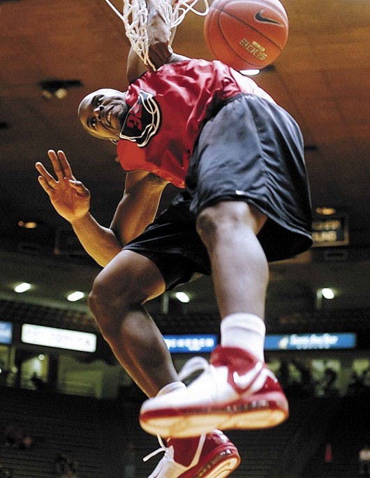Tony Danridge dunks during the Cherry-Silver Games slam dunk competition at The Pit on Friday. Danridge won the competition with what the announcer called the "stick-your-hand-in-the-cookie-jar dunk." .