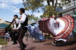 Roberto C. Rodriguez, left, and Isela Hernandez, right, members of UNM's Grupo Folklorico Lumbre, dance Saturday on the Old Town Plaza during Cultural Treasures Day.