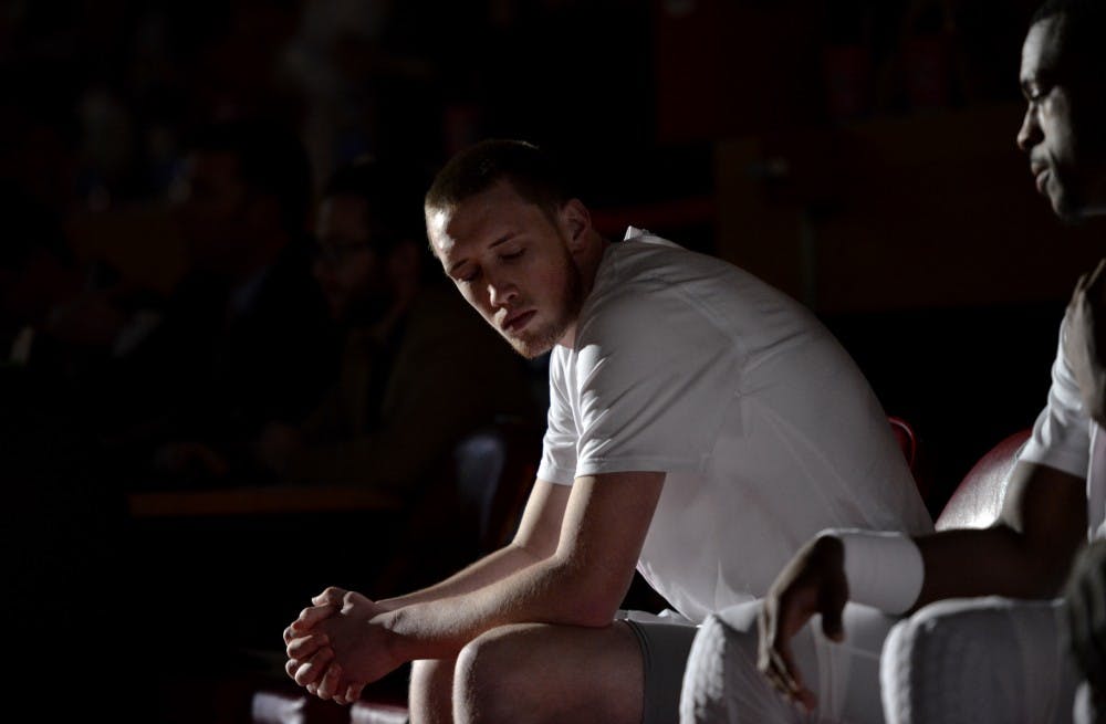 Redshirt sophomore guard Cullen Neal (left) sits along side teammates as the starting line up is called Saturday, Feb. 13, 2016 at WisePies Arena. 