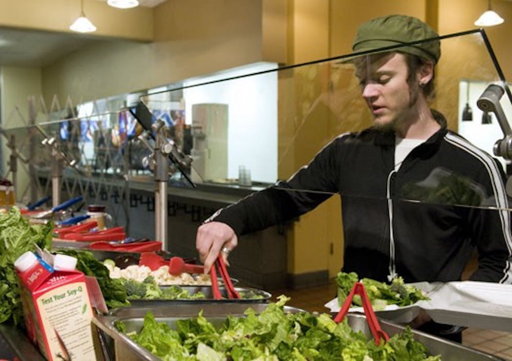 Student Martin McGrigor prepares a salad Sunday at La Posada.