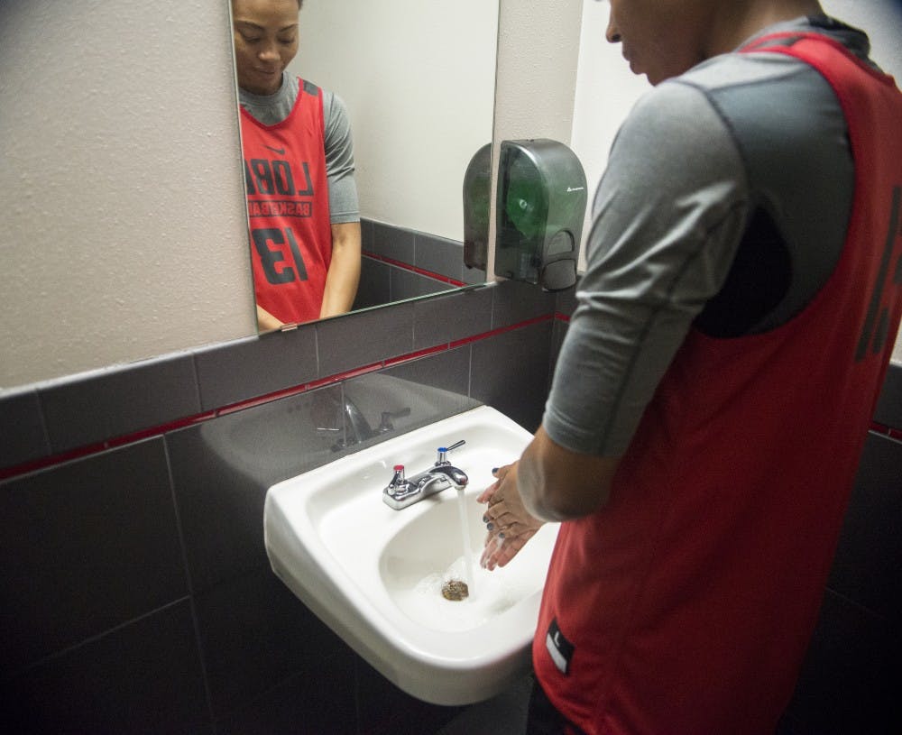 Lobos forward Khadijah Shumpert demonstrates her pre-game superstition at the Davalos Training Center Saturday, Oct. 24, 2015. Khadijah’s ritualistic superstition involves her washing her hands five times before setting foot on the court.