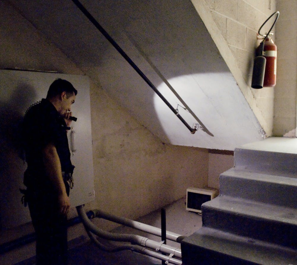 	UNM Police Department officer Chris Carabajal checks a nook near Theater X in the Center for the Performing Arts. Carabajal said he monitors this area after finding a homeless man in a previous occasion