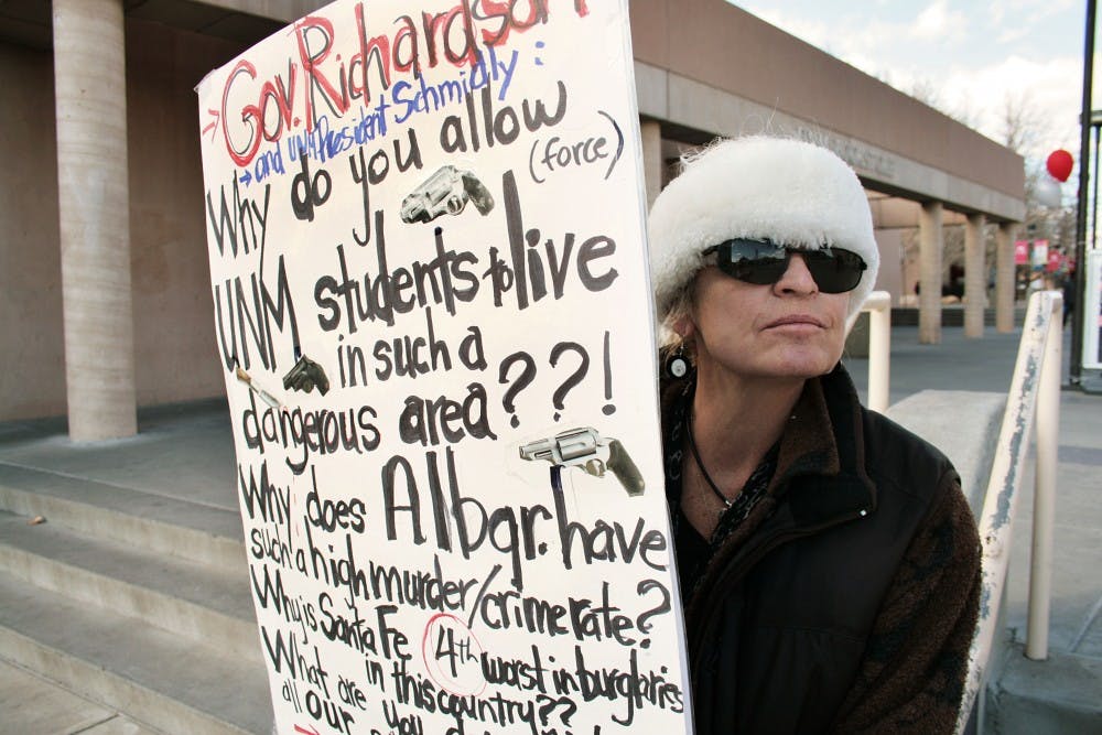 	Larissa Lewis stands in front of the UNM bookstore and pickets for safety reform in Albuquerque and Santa Fe. After her son, student Kerry Lewis, was murdered last summer, Larissa has been protesting both in town and at the state legislature to make progress toward safety. The Monday night stabbing prompted her appearance at UNM. “You have to provoke people, you have to push buttons,” she said.