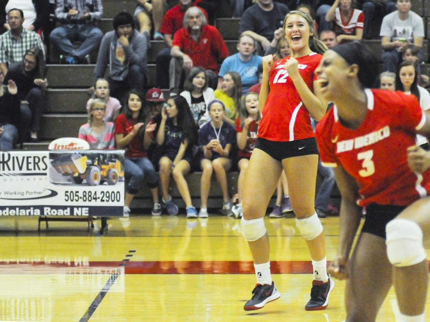 Lobos sophomore outside hitter/middle blocker Cassie House and redshirt senior right side hitter Chantale Riddle, left to right, react after scoring a point during the game against UC Irvine at Johnson Gym on Saturday night. The Lobos defeated UC Irvine 3-1.
