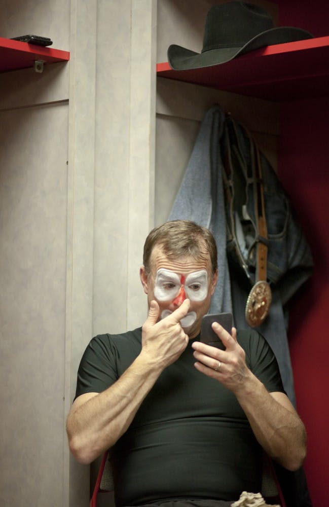 Professional Bull Riders entertainer Flint Rassmesen puts makeup on Saturday night before the second day of the 16th Ty Murray Invitational. Rassmesen used to be a high school math and history teacher in Montana. This is his 15th time coming to Albuquerque. 