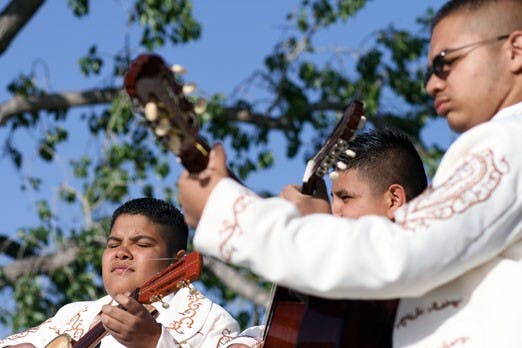 Mariachis Dorados de Villa perform during a May Day celebration at Tiguex Park on Thursday. 