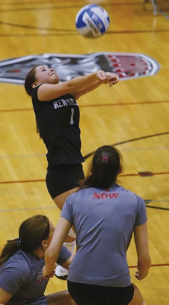 Gayle Tripp hits the ball over the net during a victory against New Mexico Highlands at Johnson Center on Saturday.  