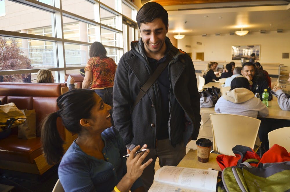 James Besante, (right) recipient of The Nicholas Skala Student Activist award jokes about a class with Aditi Majumdar (left), fellow medical student in the cafeteria at UNM Hospital.