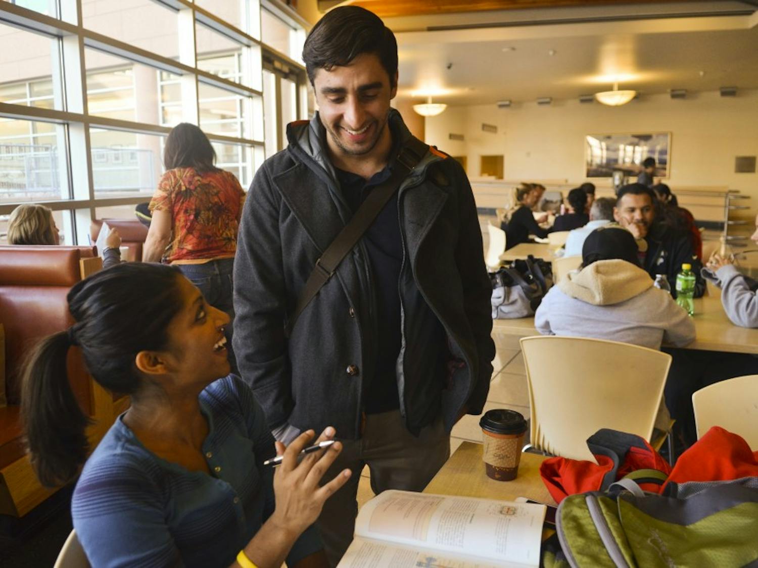 James Besante, (right) recipient of The Nicholas Skala Student Activist award jokes about a class with Aditi Majumdar (left), fellow medical student in the cafeteria at UNM Hospital.