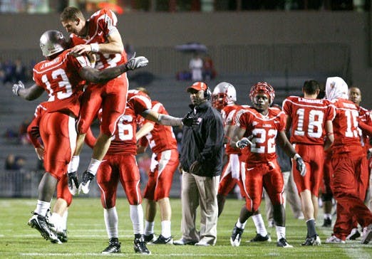 Lobo tailback James Wright, left, celebrates with backup quarterback Tate Smith after a touchdown against Wyoming at University Stadium on Saturday. UNM beat the Cowboys 24-0. 