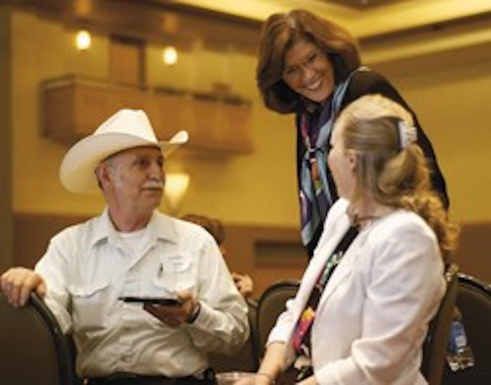 Susan Carkeek, middle, UNM vice president of human resources, talks with the UNM operations manger of physics and astronomy Elliott S. Bailey, left, and his wife Ona Bailey after celebrating 200 faculty and staff members' for their services Wednesday in t