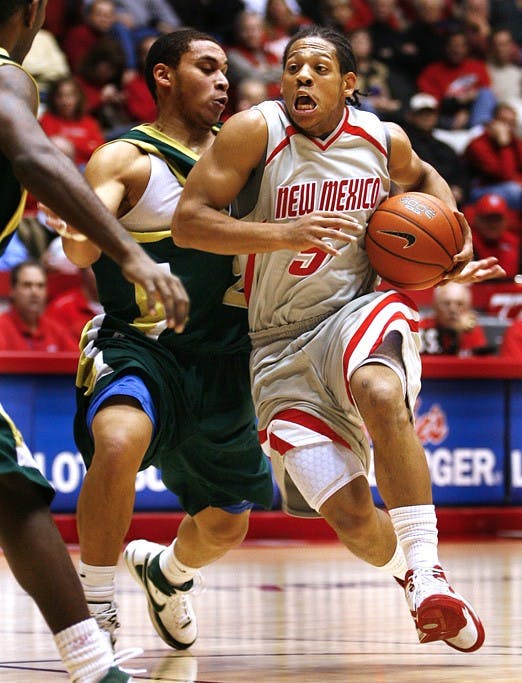 UNM's Dairese Gary moves around Colorado State's Jesse Woodard during their game at The Pit on Tuesday. Lobos win...