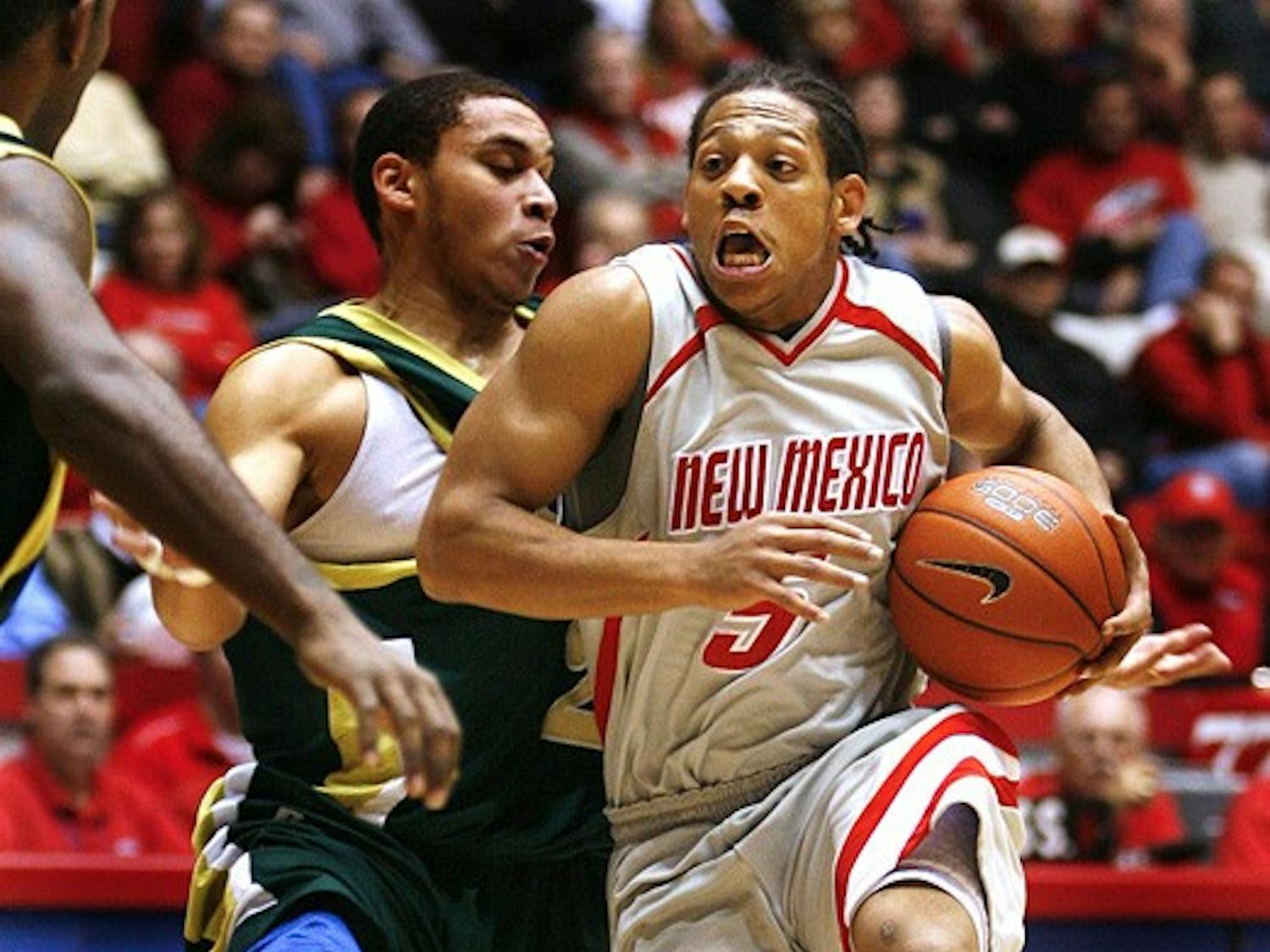 UNM's Dairese Gary moves around Colorado State's Jesse Woodard during their game at The Pit on Tuesday. Lobos win...