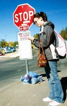 UNM student Victoria Youngblood waits for the Q Lot bus on the corner of Yale Boulevard and Camino de Salud on Monday. The stop is one of three to be closed for construction starting 