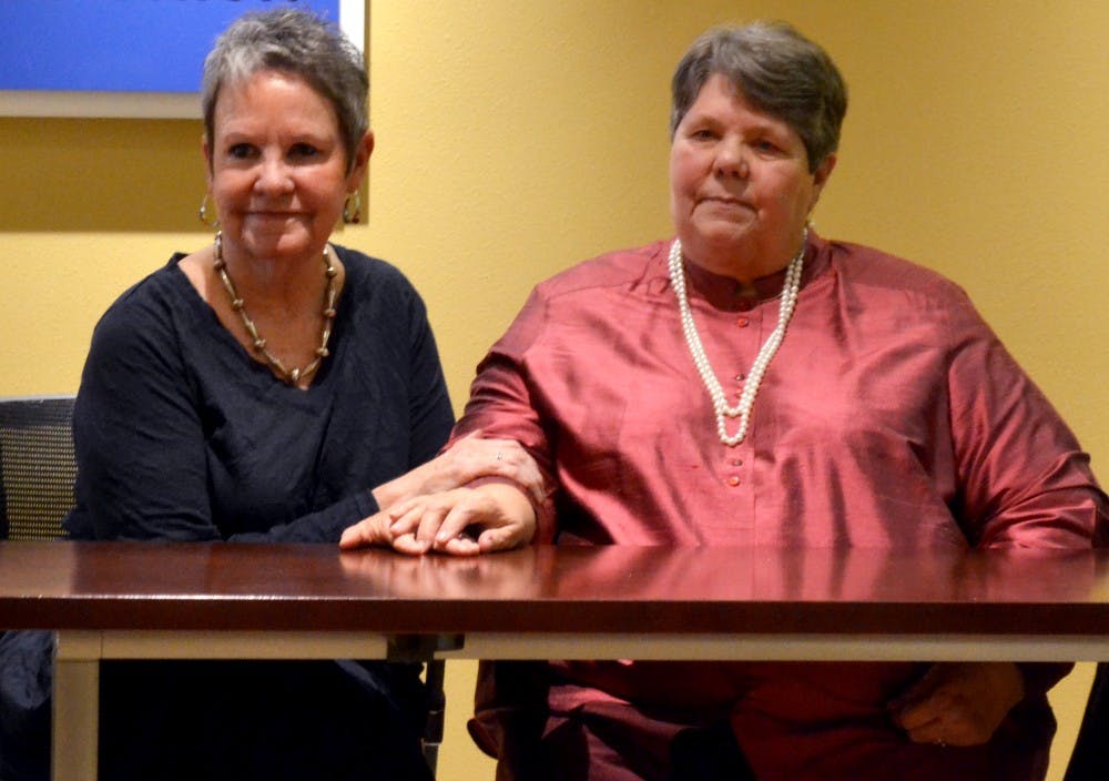 Ona Porter, left, and Miriam Rand sit hand-in-hand during a press conference at the American Civil Liberties Union of New Mexico headquarters Thursday as they discuss the New Mexico Supreme Court ruling that approved same-sex marriage statewide. Porter and Rand, who have been in a relationship for roughly 26 years, were among the plaintiffs in a case regarding same-sex marriage brought by the state's county clerks to the Supreme Court three months ago.