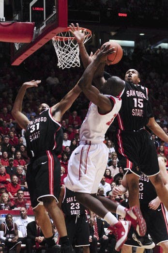Tony Danridge double clutches a fadeaway jumper over SDSU's Lorrenzo Wade, left, and Kyle Spain. Danridge had 25 points in the Lobos' 75-49 victory Saturday at The Pit.