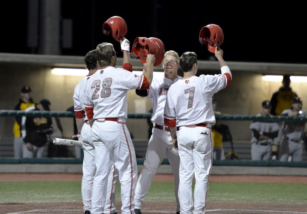 The Lobos celebrate at home plate after junior Chris DeVito hits a home run bringing in three runners Friday night at Santa Ana Star Field. The Lobos beat Witchita State 17-7 in their first in three game series. 