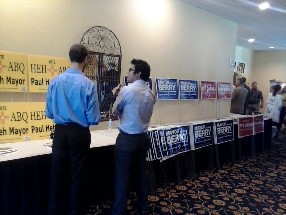 	Audience members look at the campaign posters at a candidate forum for Albuquerque&#8217;s mayoral election Monday at Albuquerque Marriott. All three candidates, Richard Berry, Pete Dinelli and Paul Heh, fielded questions during the forum.