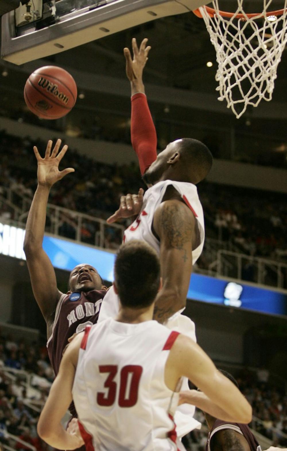 	A.J. Hardeman contests a shot from Montana&#8217;s Anthony Johnson on Thursday at HP Pavilion. The Lobos survived and advanced to face No. 11 Washington on Saturday.