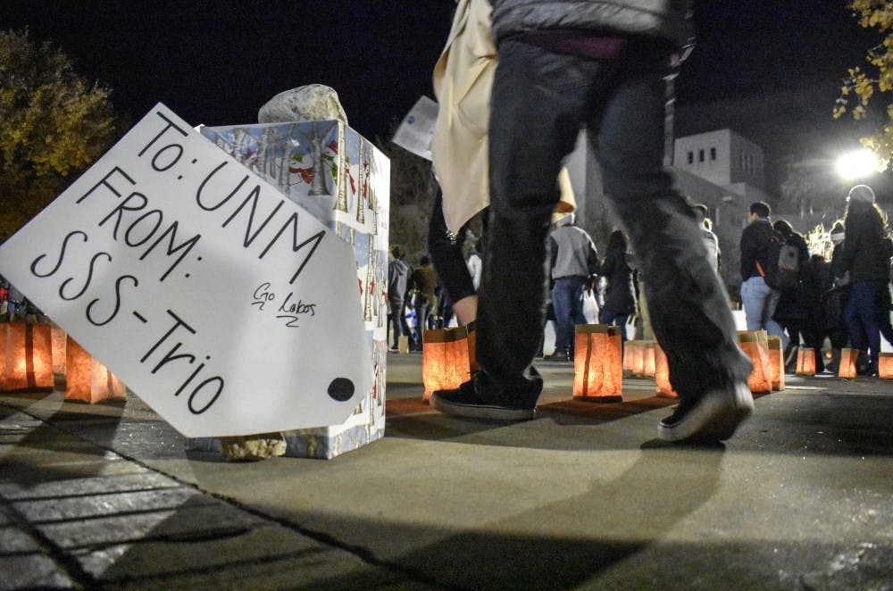 University of New Mexico students walk toward Smith Plaza during the Hanging of the Greens on Friday, Nov. 30.