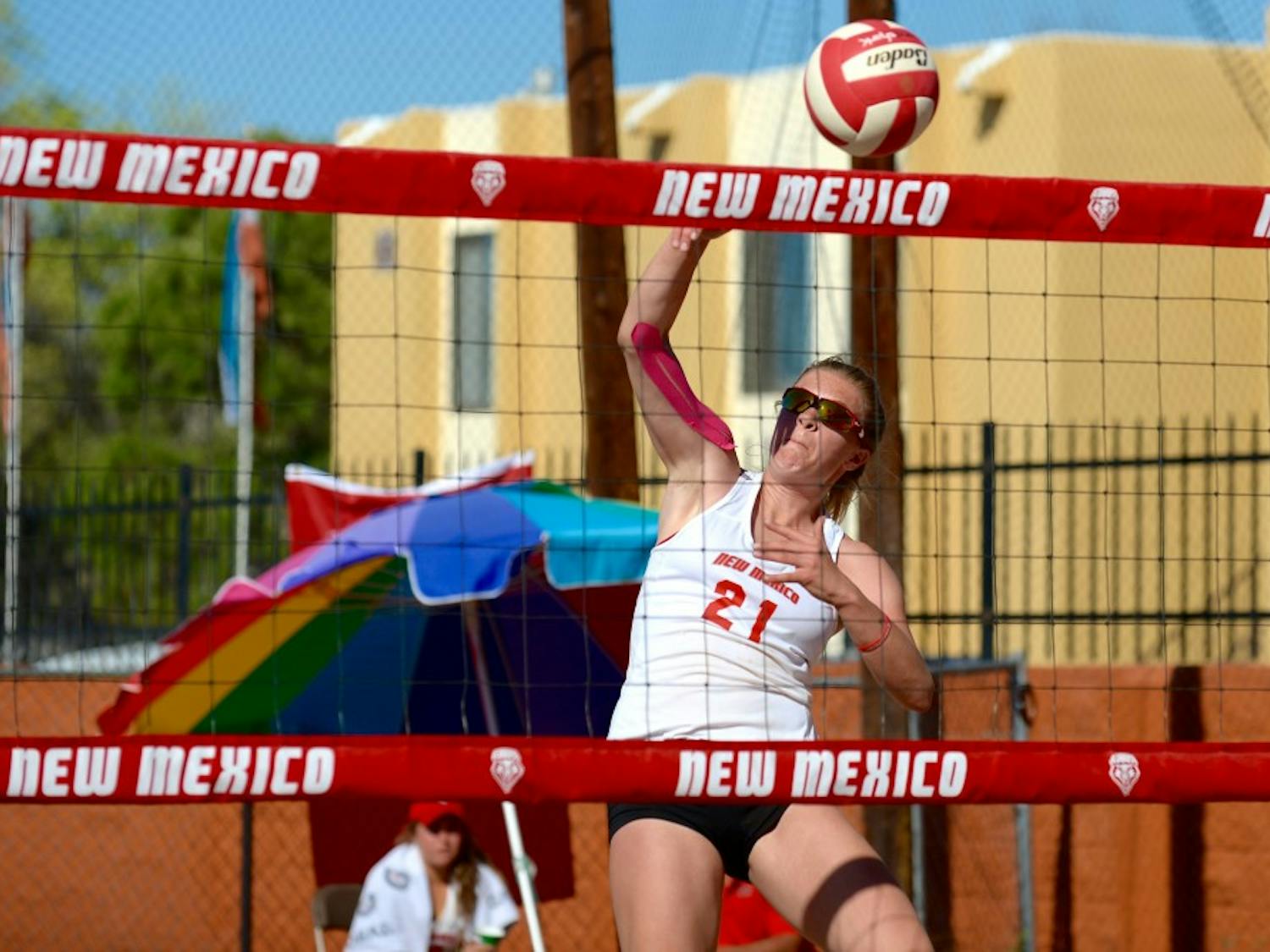 Junior&nbsp;Julia Warren sets up for a kill&nbsp;against A New Mexico State player&nbsp;Saturday afternoon&nbsp;Lucky 66 Bowl's sand volleyball courts.&nbsp;The Lobos beat the Aggies 5-0 and swept the weekend.&nbsp;