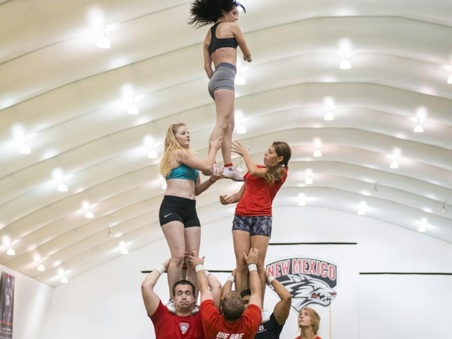 The New Mexico spirit squad practices drills at the Football Indoor Practice Facility Aug. 9, 2015.