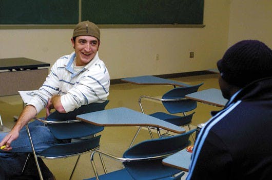 Student and veteran Ben Mills talks to classmate Kiyun Lynch on Wednesday during his microeconomics class taught by Tyler Prante. Mills served in the Navy and used the GI Bill to attend UNM. 
