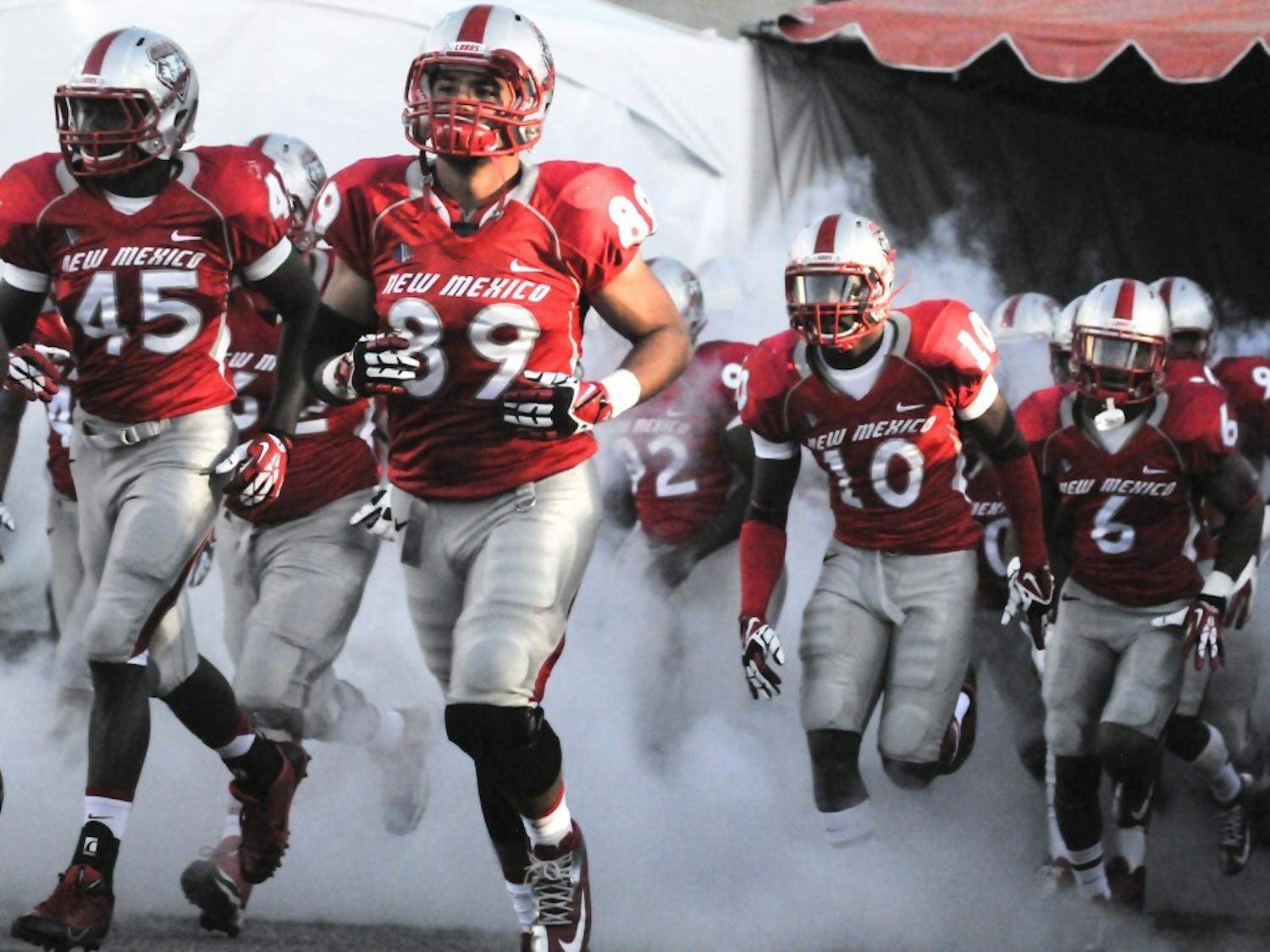 The New Mexico football team makes an entrance onto University Stadium before the start of the game against UNLV last September. The Lobos’ 2014 season kick-off begins on Saturday at 6 p.m. against UTEP at University Stadium.