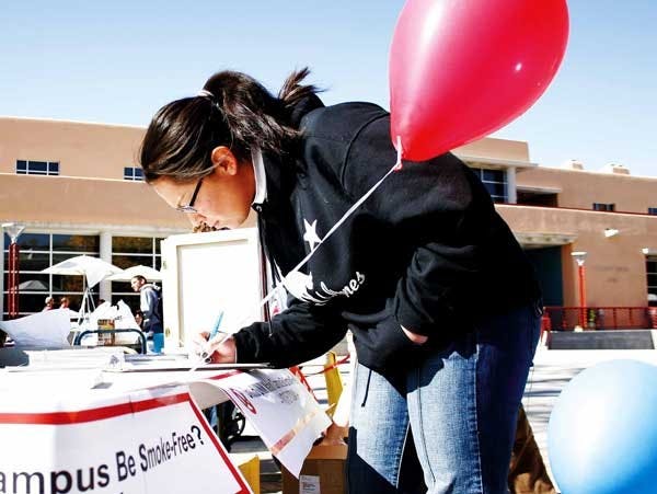 UNM student Adriana Guiterrez fills out an opinion poll Thursday outside the SUB that asks whether Main Campus should be smoke-free.