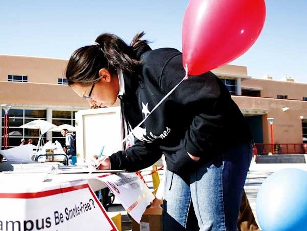 UNM student Adriana Guiterrez fills out an opinion poll Thursday outside the SUB that asks whether Main Campus should be smoke-free.