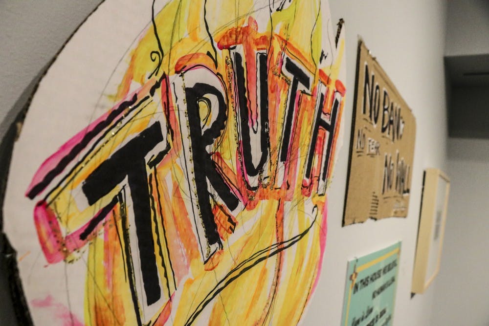 A sign used in Albuquerque protests named “Truth,” created&nbsp;by Raychael Stine, hangs in the Albuquerque Art Museum on Feb. 2, 2018.