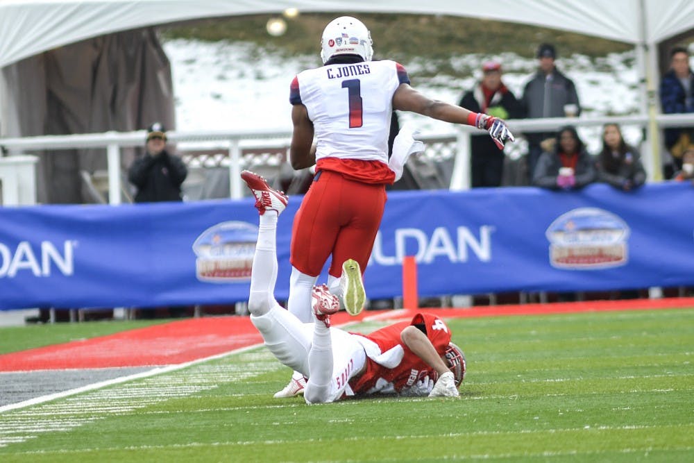 Arizona red shirt junior wide receiver Cayleb Jones breaks through Lobo's Isaiah Brown at University Stadium Saturday afternoon. The Wild Cats beat the Lobos 45-37 in the 10th Gildan New Mexico Bowl. 