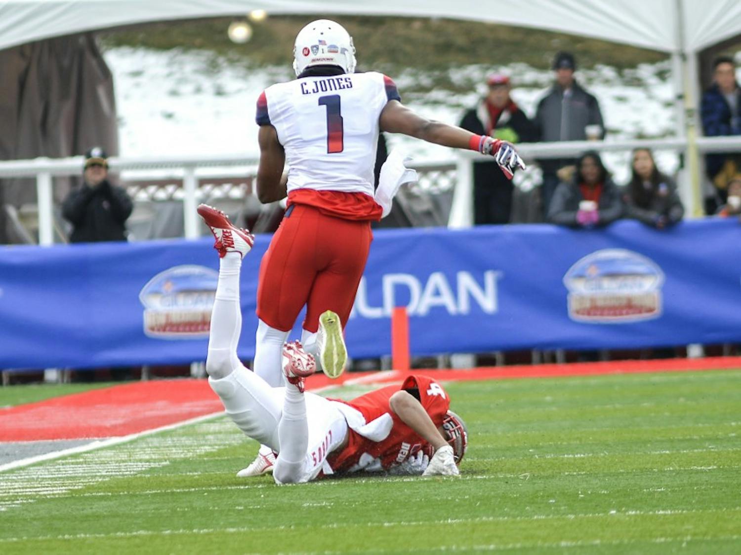 Arizona red shirt junior wide receiver Cayleb Jones breaks through Lobo's Isaiah Brown at University Stadium Saturday afternoon. The Wild Cats beat the Lobos 45-37 in the 10th Gildan New Mexico Bowl.
