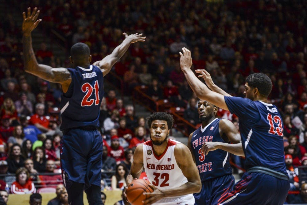 Redshirt senior forward Tim Williams prepares to jump to the net while being covered by Fresno State defenders Wednesday, Dec. 28, 2016 at WisePies Arena.&nbsp;