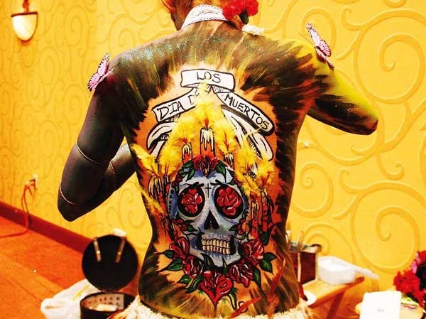 Catherine Owens exhibits "Dia de los Muertos" by Kayla Mansfield at the U.S. Body Painting Festival at the Embassy Suites on Saturday. 