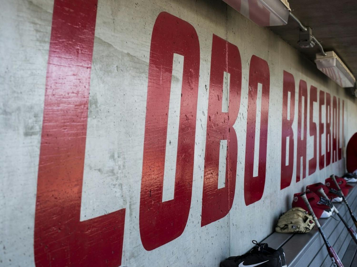 University of New Mexico head baseball coach Ray Birmingham sits against the wall of the home dugout at Santa Ana Star Field during the Lobos annual media day on Feb. 9, 2018. The Lobos open the season this Friday against Oregon State.