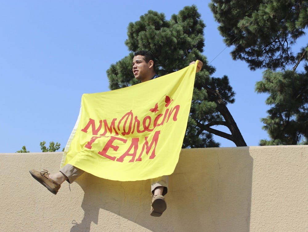 UNM student Jorge Guerrero raises a NM Dream Team Flag on Sept. 5, 2017 in support of the DACA program. Trump recently announced the rescission of DACA with a six month delay, asking Congress to take action.  