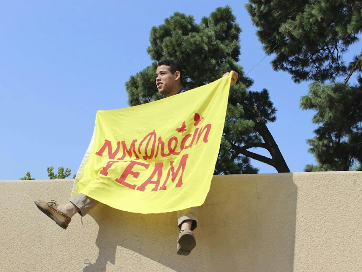 UNM student Jorge Guerrero raises a NM Dream Team Flag on Sept. 5, 2017 in support of the DACA program. Trump recently announced the rescission of DACA with a six month delay, asking Congress to take action.  