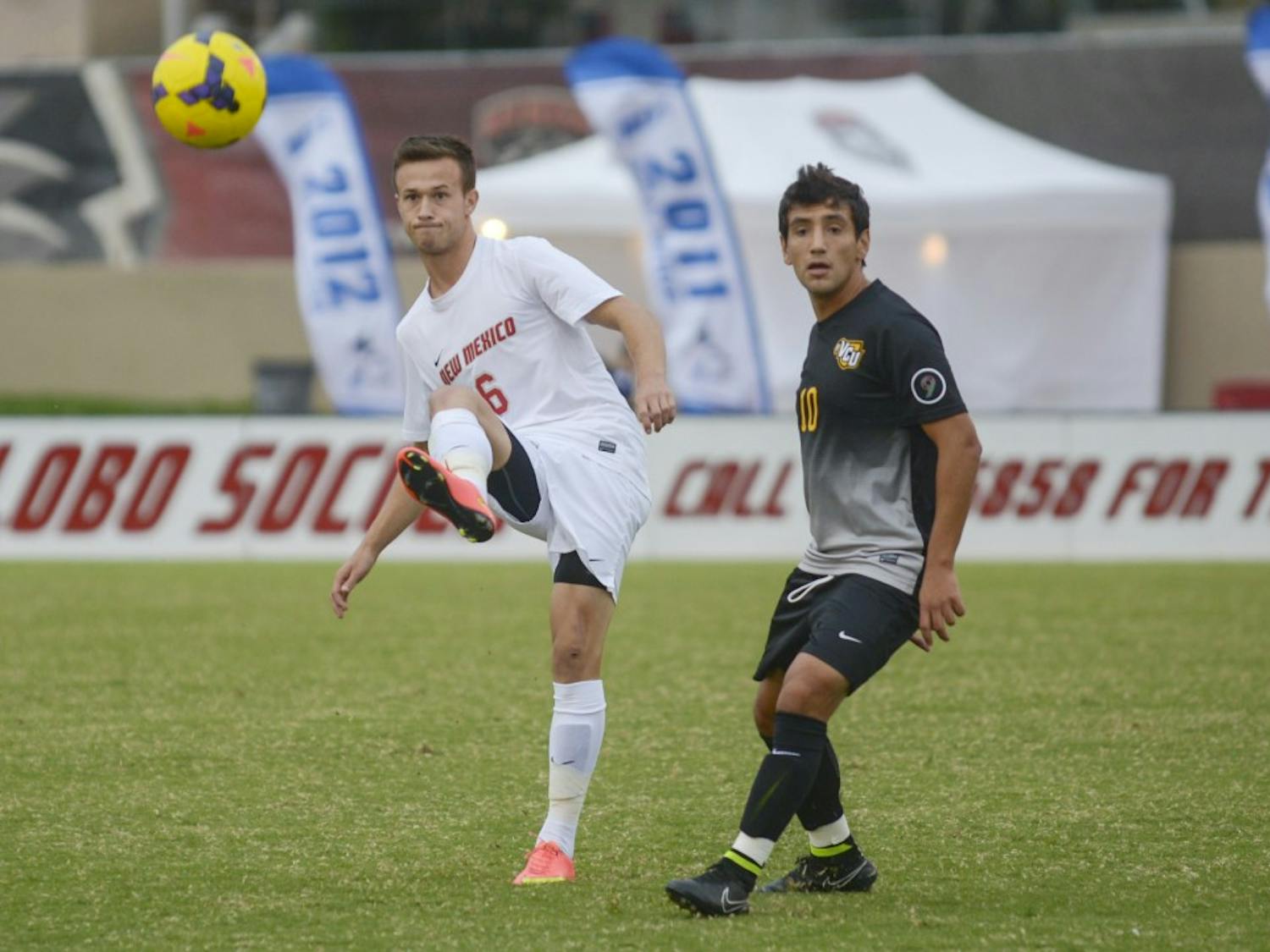 Lobo junior midfielder Ben McKendry kicks the ball away from VCU senior midfielder Mario Herrera Meraz during the game against VCU ar Lobo Soccer Complex on Sunday afternoon. The Lobos will be playing against Charlotte in North Carolina tonight at 7 p.m.