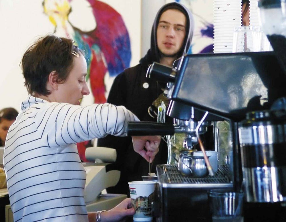 Barista Te&aacute; Nielsen makes a latte for Tyson "Chicken" Annicharico, the bassist of San Francisco band Dead to Me, on Monday at Irysh Mac's on Yale Boulevard. Irysh Mac's will close Jan. 27.