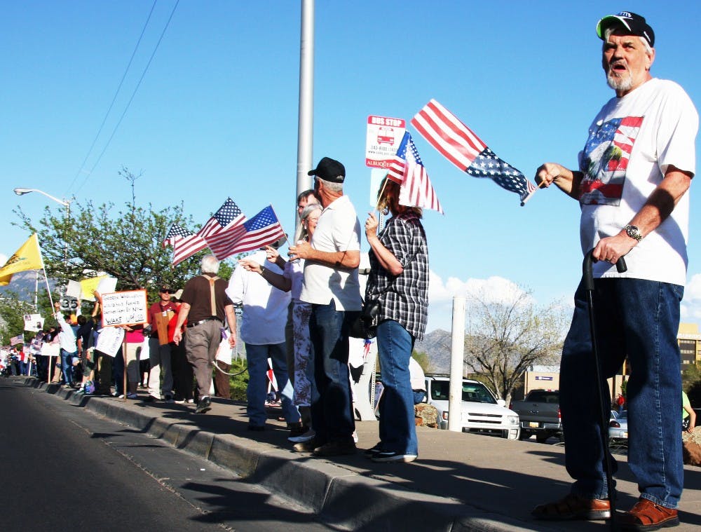 	Activists stands on Menaul Boulevard during the American Tea Party’s Tax Day Rally on Thursday. About 500 people gathered on Menaul for the demonstration.