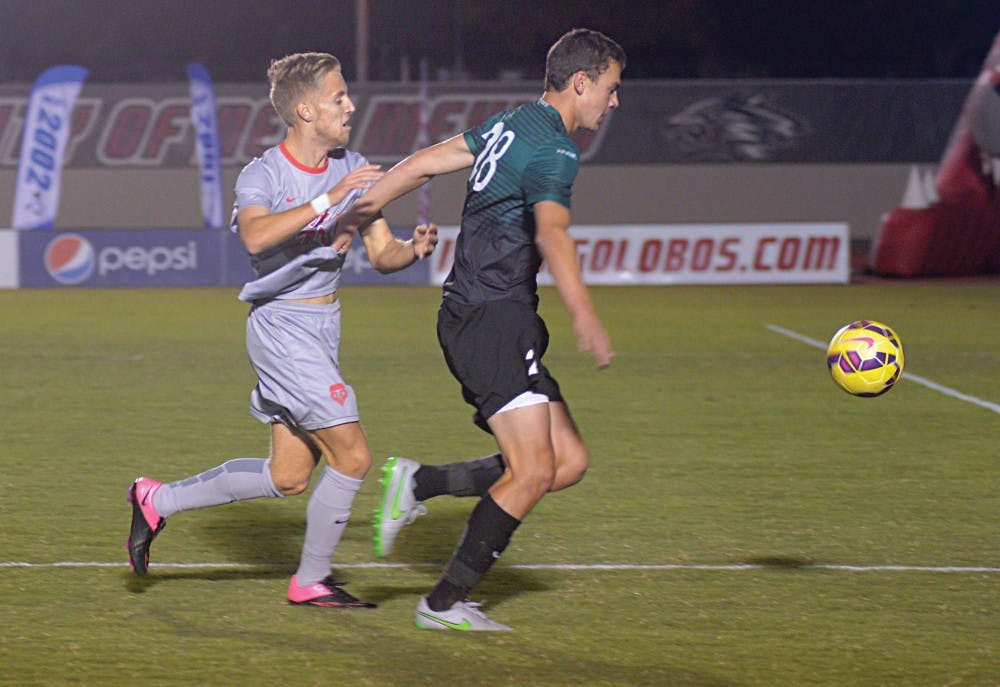 New Mexico forward Sam Gleadle battles a Charlotte player for the ball during their game at the UNM Soccer Complex Oct. 27. The Lobos play Florida Atlantic at 7 p.m. Friday in hopes of qualifying for the Conference USA tournament.