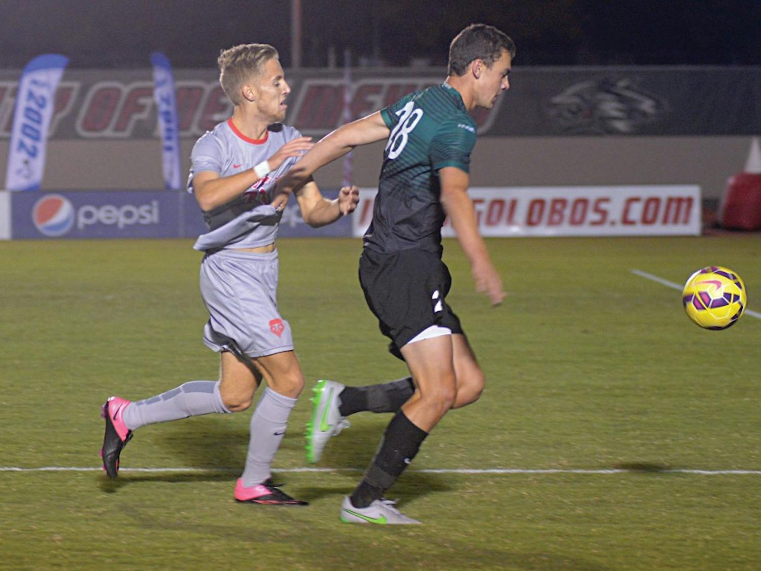 New Mexico forward Sam Gleadle battles a Charlotte player for the ball during their game at the UNM Soccer Complex Oct. 27. The Lobos play Florida Atlantic at 7 p.m. Friday in hopes of qualifying for the Conference USA tournament.